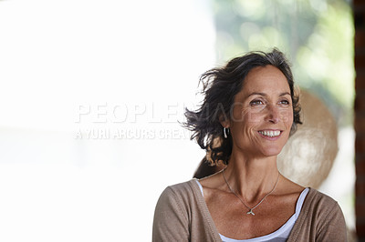 Buy stock photo Shot of an attractive mature woman relaxing at home