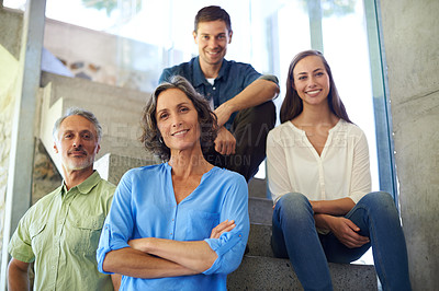 Buy stock photo Shot of a mother and father standing in front of their adult children on the stairs
