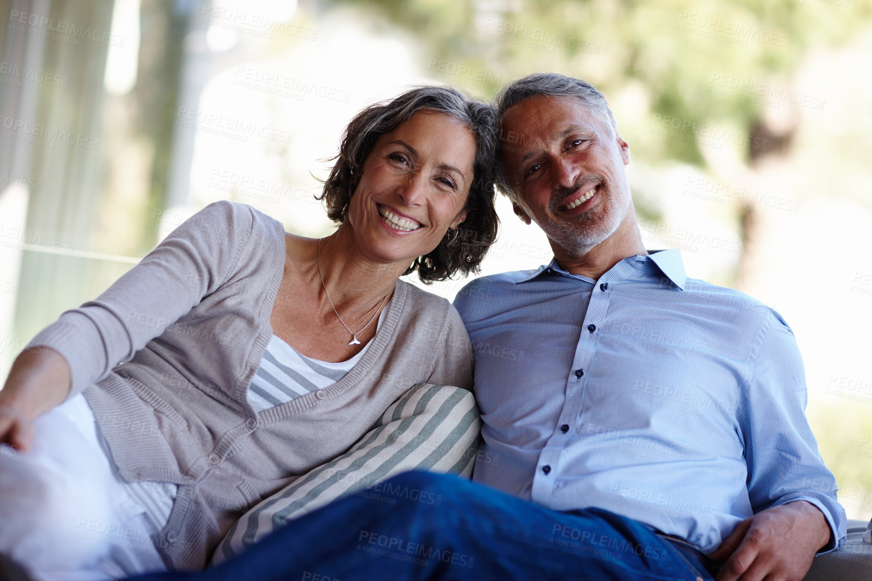 Buy stock photo Portrait, love and senior couple on a couch, romance and relationship with happiness, home and retirement. Face, mature man and old woman on a sofa, romantic and marriage with bonding and loving