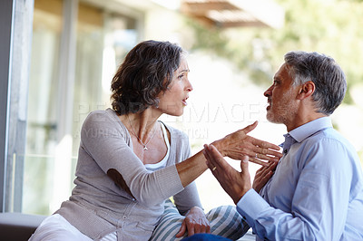 Buy stock photo Divorce, fight and mature couple at home with anger, stress or frustrated by cheating, liar or conflict. Marriage, crisis or aggressive people argue on a patio with doubt, confrontation or disaster