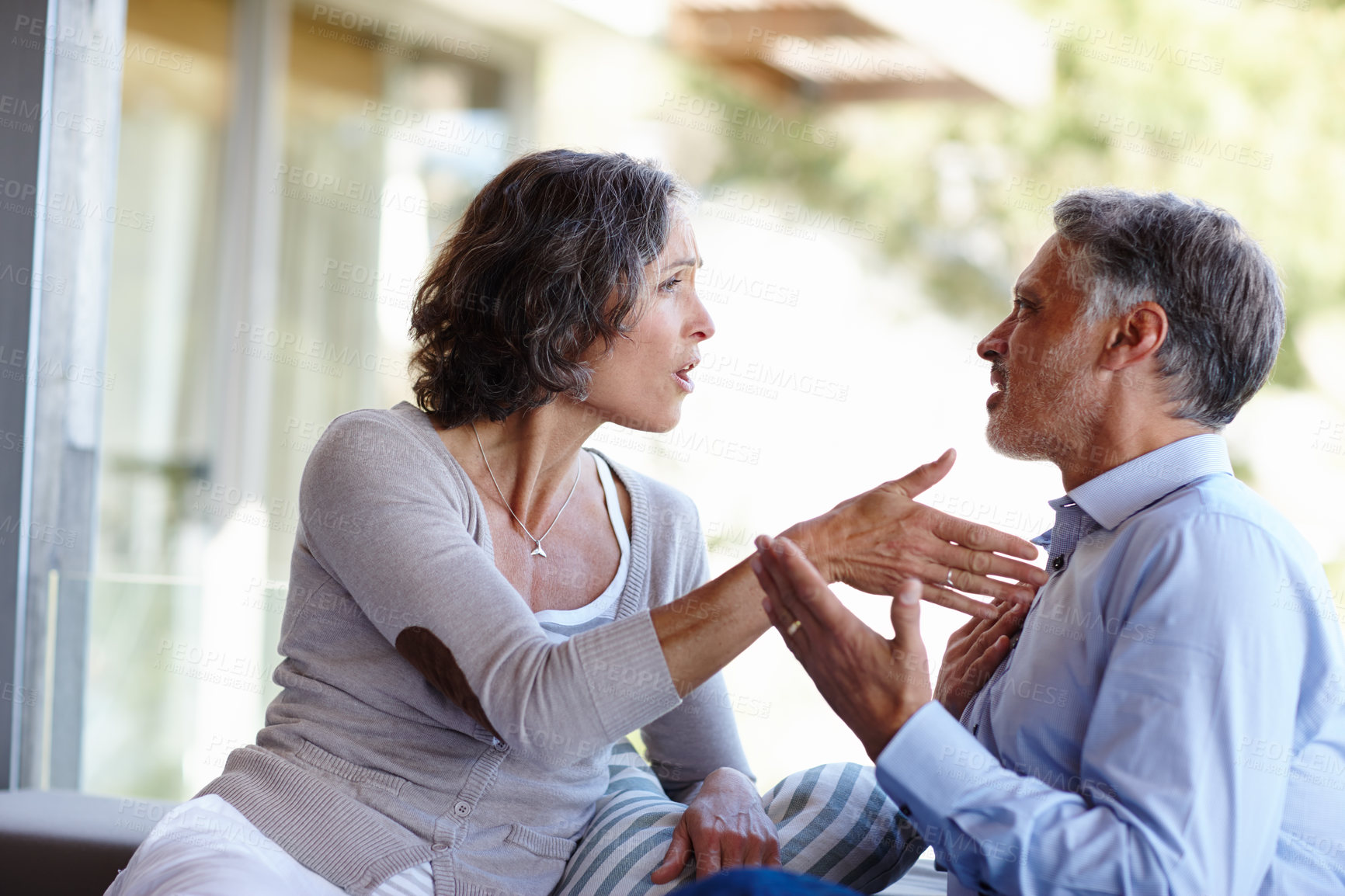 Buy stock photo Divorce, fight and mature couple at home with anger, stress or frustrated by cheating, liar or conflict. Marriage, crisis or aggressive people argue on a patio with doubt, confrontation or disaster