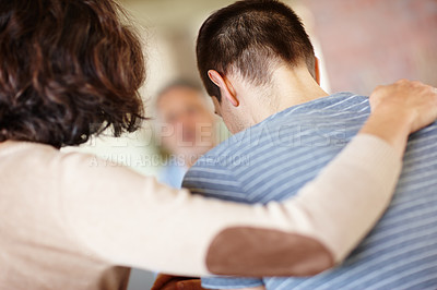 Buy stock photo A rear view shot of a caring mother consoling her adult son