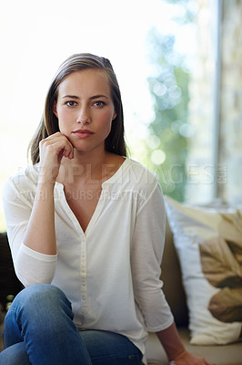 Buy stock photo Woman, portrait and confident in home on sofa with serious face for pensive mood or quiet contemplation and inner thoughts. Female person, couch and thinking or wondering in living room and calm.