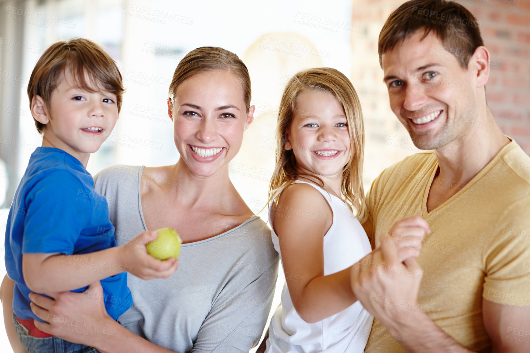 Buy stock photo Portrait, smile and family in home for love, bonding and siblings together with fruit. Face, happy parents and kids in living room for connection with mother, father or children eating apple in house
