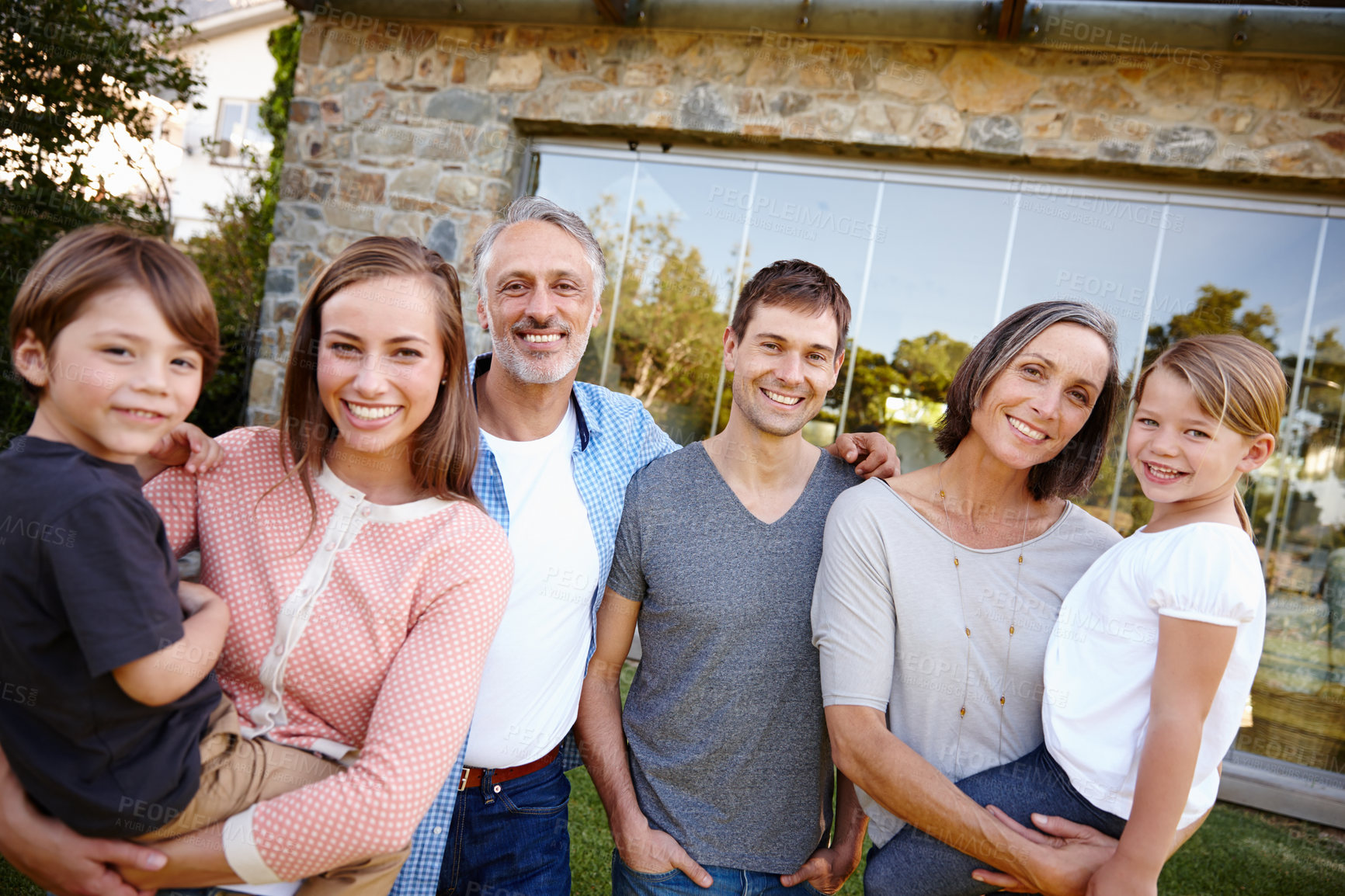 Buy stock photo Portrait, smile and big family outdoor together by home for love and bonding at backyard. Face, parents and happy grandparents with kids at garden for connection with mother, father and children