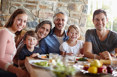 Buy stock photo A portrait of a happy multi-generational family having a meal together outdoors