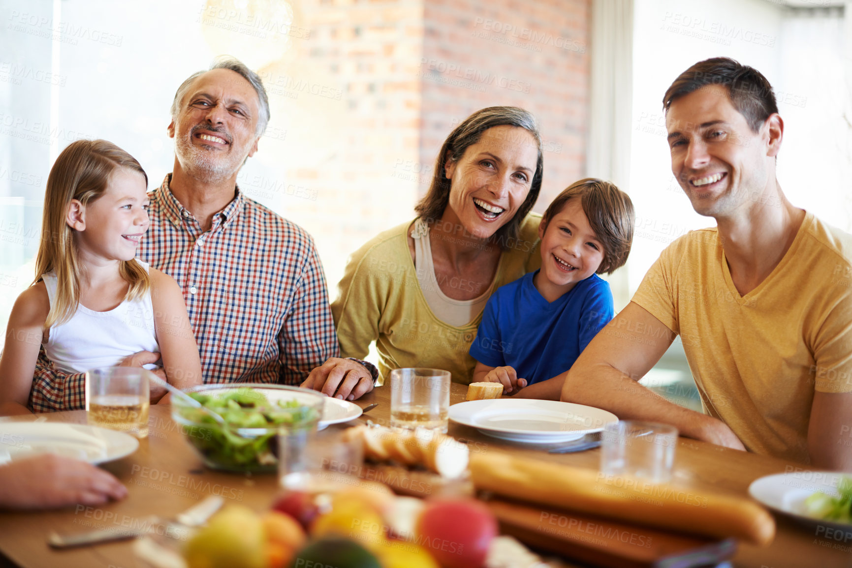 Buy stock photo Family, healthy and lunch table with food for eating, wellness snack with generations or grandparents together. Happy, home and nutrition or vitamins in meal for child, salad or fruits with beverages