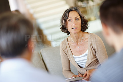 Buy stock photo Female therapist, people and meeting on sofa for mental health, therapy and consultation. Mature advisor, family and discussion on couch with notes for advice, session and listening or wellness