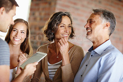 Buy stock photo Shot of a happy family having a discussion
