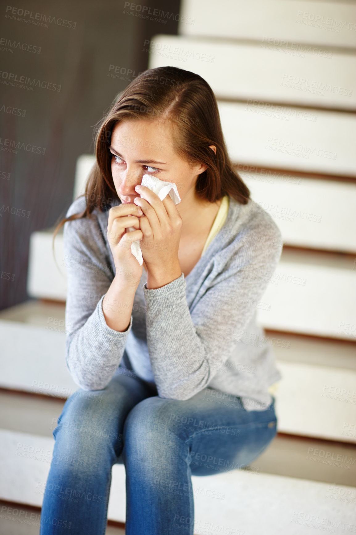 Buy stock photo Crying, stress or woman in house with tissue, depression or mental health, crisis or disaster. Stairs, overthinking or person with tears, anxiety or overwhelmed by fail, mistake or ptsd trauma memory