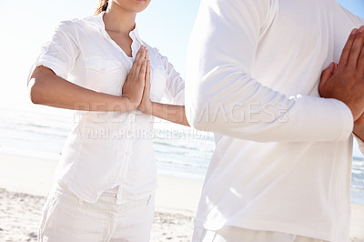 Buy stock photo Prayer hands, meditate and couple on beach for yoga, calm and wellness with sun, travel and mindfulness together. Zen, peace and natural light with fresh air, people and energy balance for nature