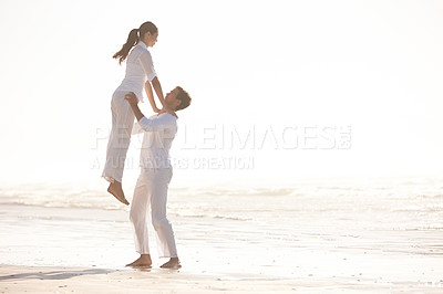 Buy stock photo Couple, beach and lifting with support for valentines day, love or outdoor summer holiday together in embrace. Man and woman by the ocean coast with vacation for romance in nature on mockup space