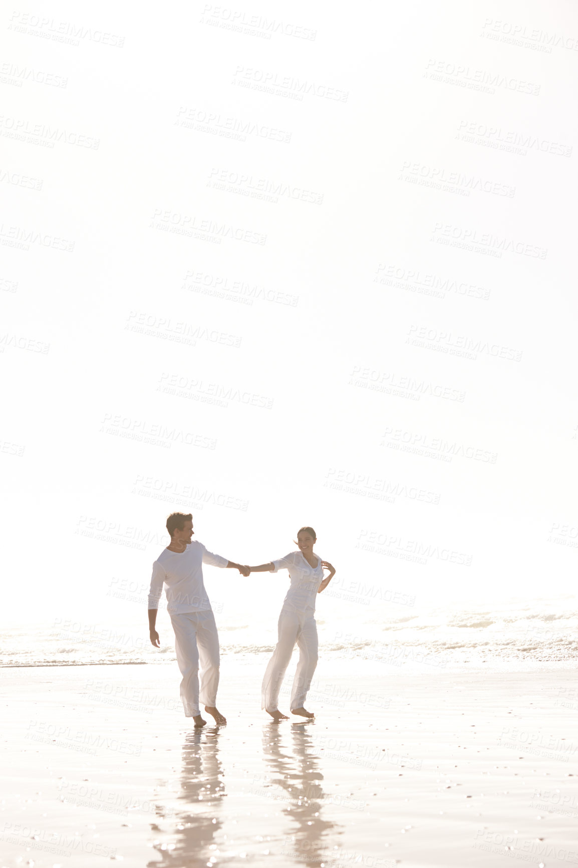 Buy stock photo Couple, ocean and holding hands for walk on beach, travel and commitment with trust and bonding outdoor. Love, care and support in relationship, honeymoon or anniversary with fun or playful in nature