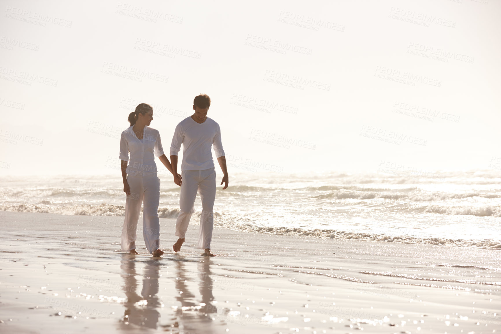 Buy stock photo Couple, ocean and holding hands while walking on beach, travel and commitment with trust and bonding outdoor. Love, care and support in relationship, honeymoon or anniversary with peace in nature