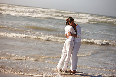 Buy stock photo Couple, hug and embrace on beach for love, support or valentines day in outdoor nature. Man and woman enjoying holiday, weekend or getaway together for bonding or romance by the ocean coast or sea