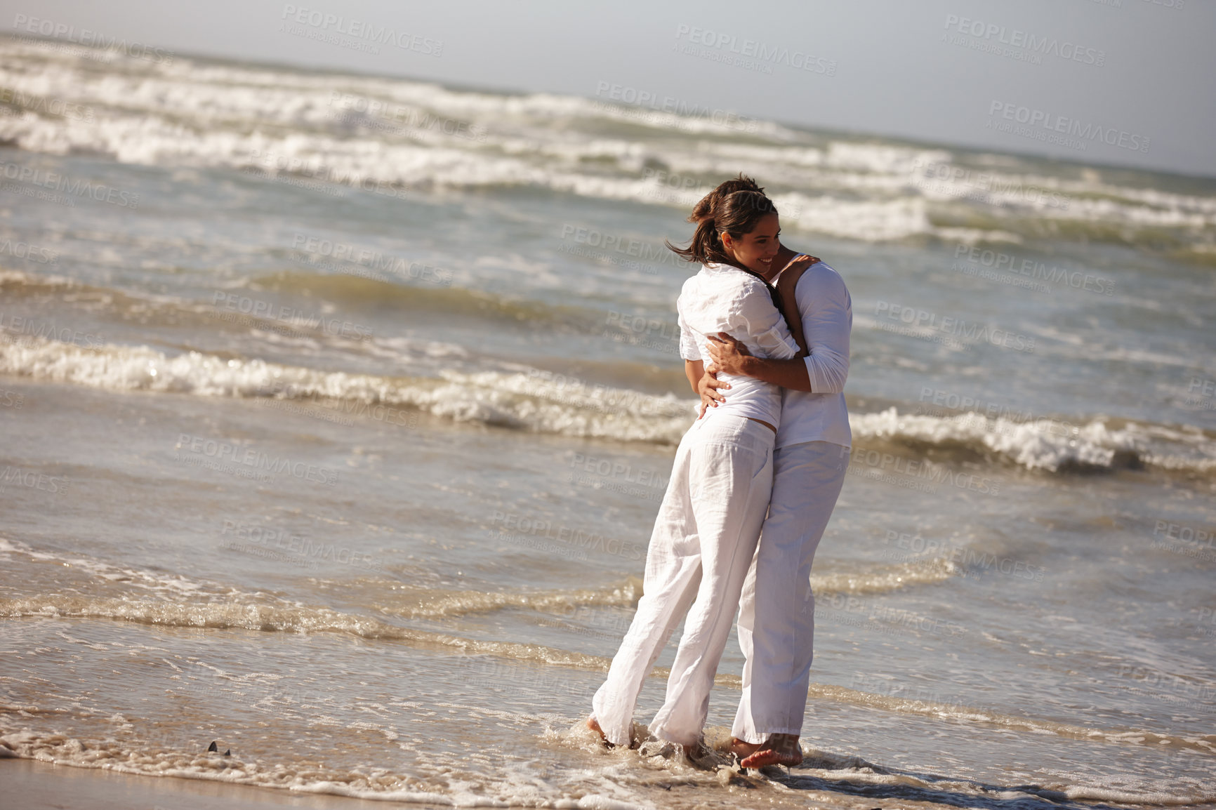 Buy stock photo Couple, hug and embrace on beach for love, support or valentines day in outdoor nature. Man and woman enjoying holiday, weekend or getaway together for bonding or romance by the ocean coast or sea