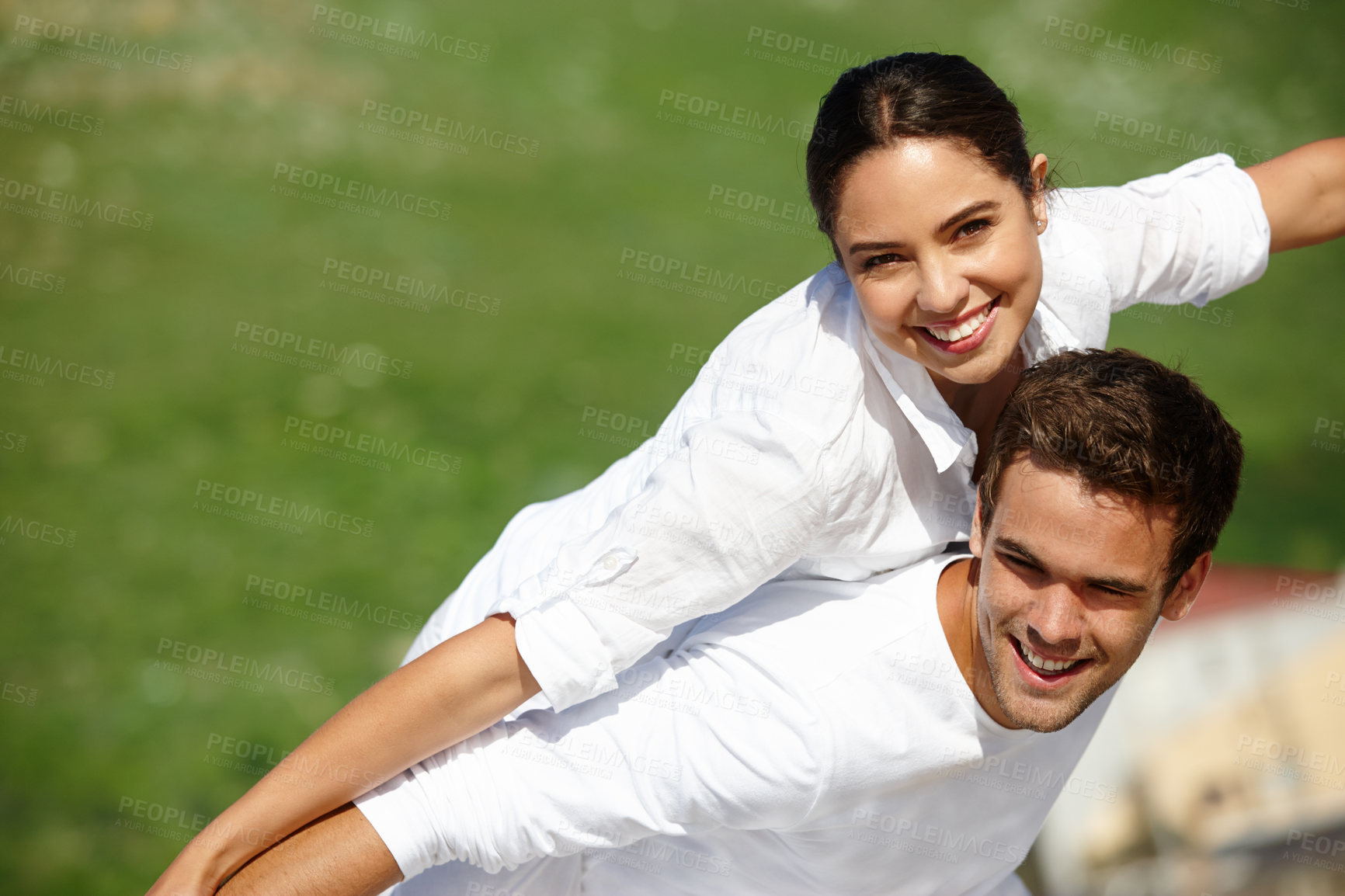 Buy stock photo Airplane, piggyback or happy couple in a park for portrait or love with support, loyalty or smile in outdoor freedom. Grass mockup space, romantic man or woman on holiday to relax for wellness or fun