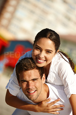 Buy stock photo Cropped shot of a young man giving his girlfriend a piggyback