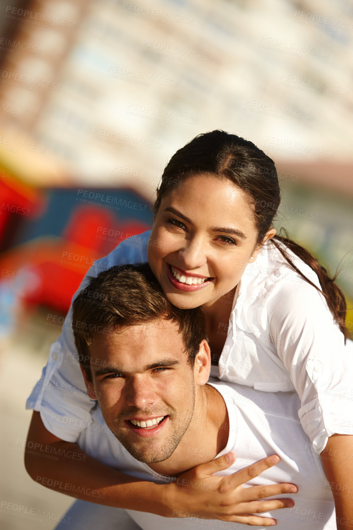 Buy stock photo Cropped shot of a young man giving his girlfriend a piggyback