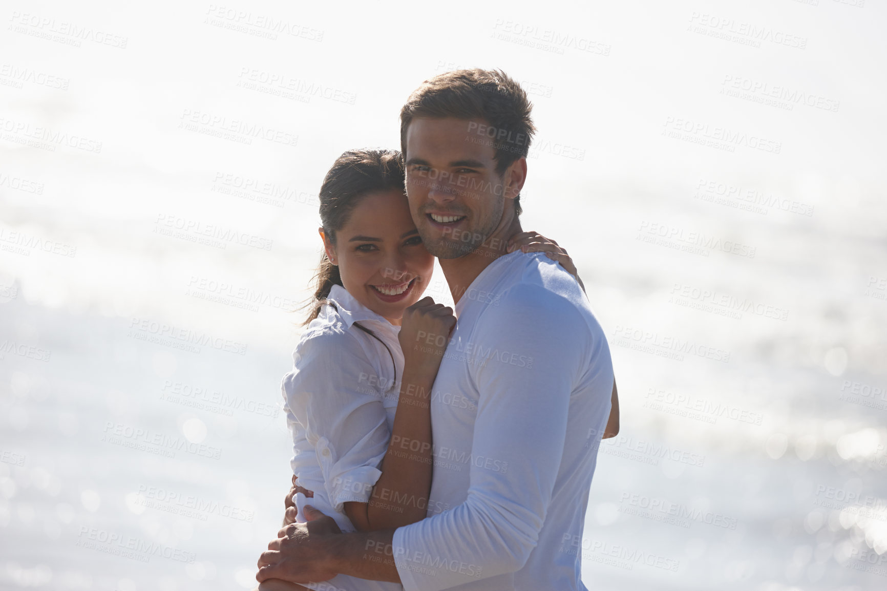 Buy stock photo Ocean, hug and portrait of couple on beach for bonding, relax together and relationship by sea. Dating, travel and happy man and woman embrace for romance on holiday, vacation and weekend in nature