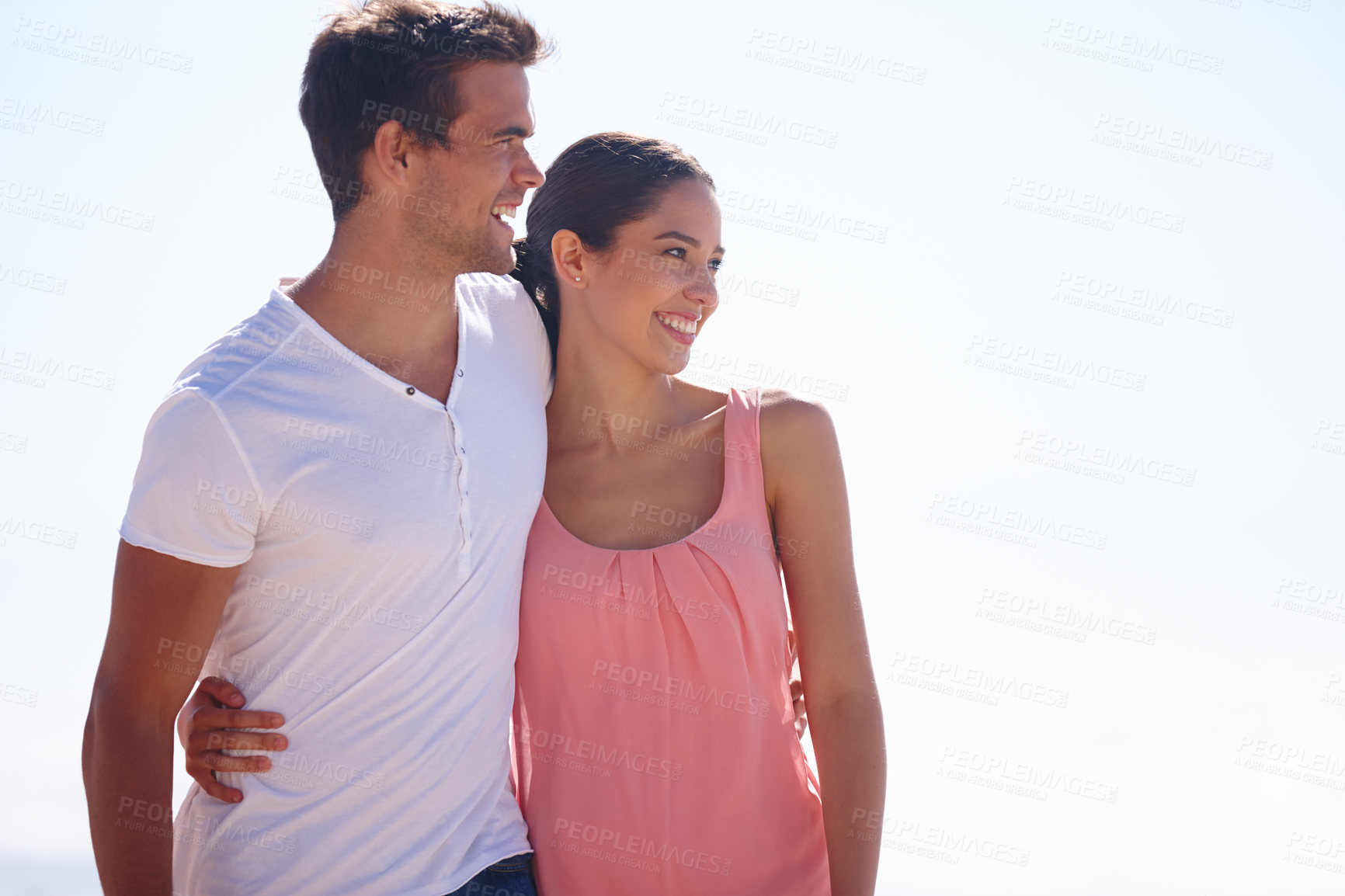 Buy stock photo Happy couple, hug and beach with embrace for love, care or romance on outdoor holiday in nature. Young man and woman with smile for weekend, vacation or getaway by the ocean coast, blue sky or mockup