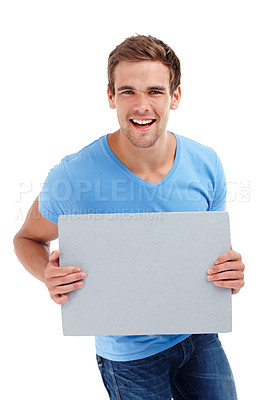 Buy stock photo Man, portrait and board in studio with poster for advertising space, presentation or promotion sign. Model, smile and cardboard for banner, announcement and mockup for information on white background