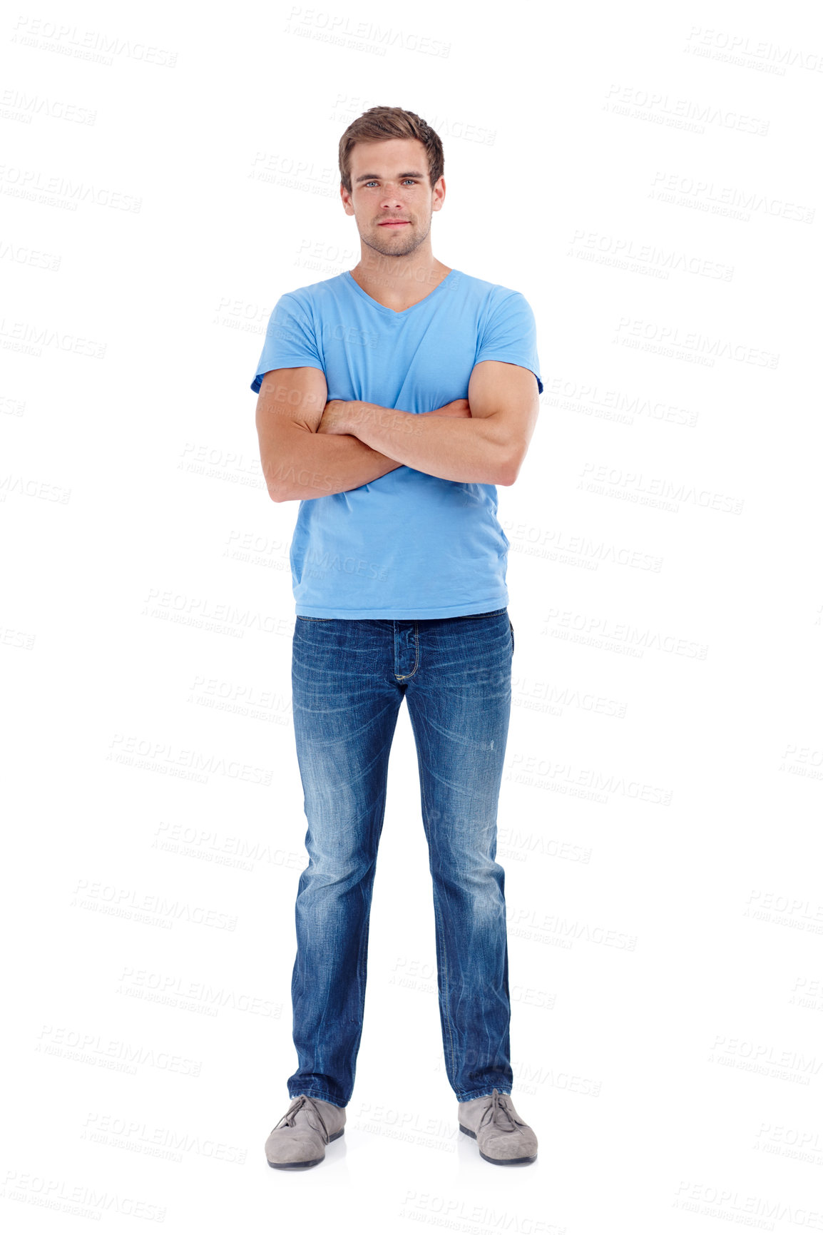 Buy stock photo Full-length of a serious looking young man in casual clothes posing against a white studio background. Confident and handsome young male in blue t-shirt and jeans. 