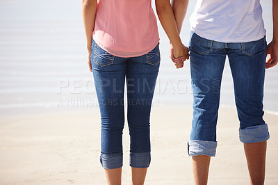 Buy stock photo Couple, care and sunshine with holding hands at beach sand for water, summer holiday and love. Man, woman and relationship together for vacation travel with romance and legs by ocean for walking date