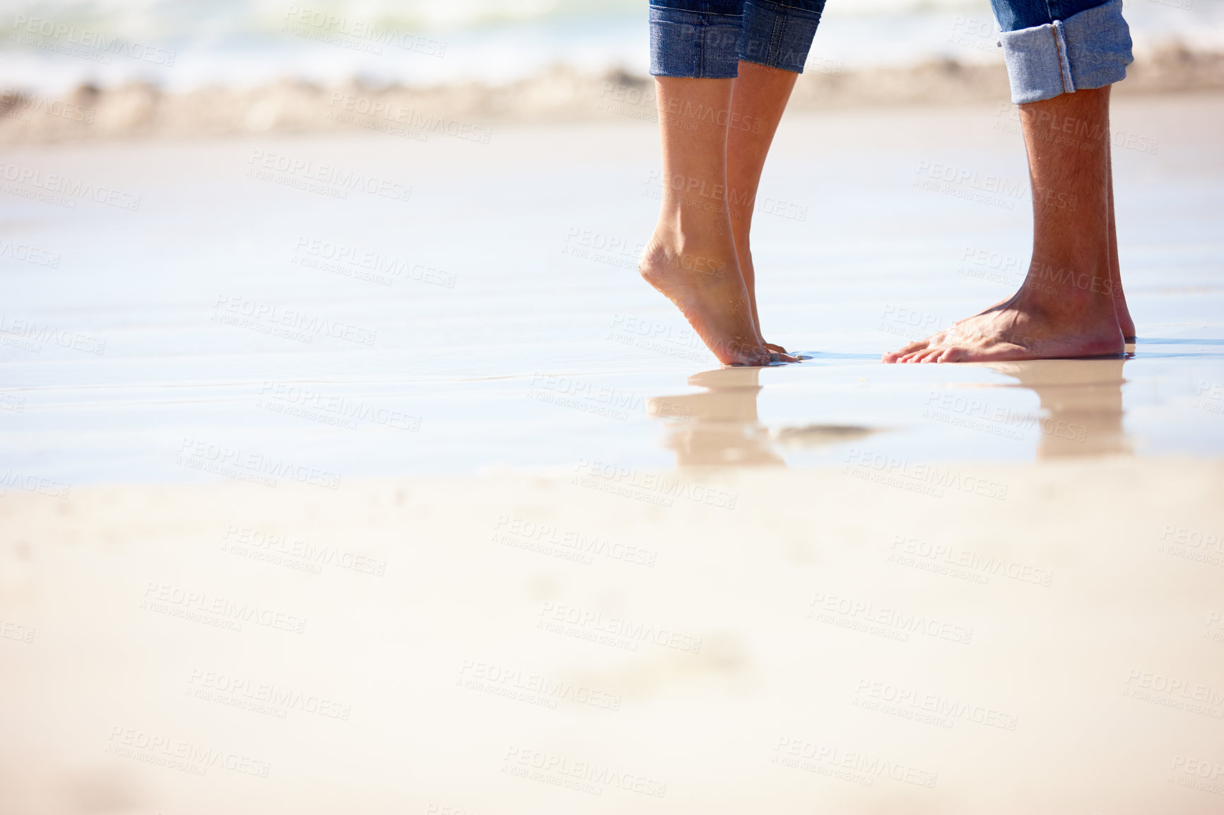 Buy stock photo Couple, feet and hug on sand at beach with romance, anniversary date and honeymoon travel on mockup space. People, legs and embrace with jeans, relax and bonding by ocean for summer holiday in Bali