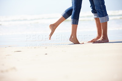 Buy stock photo Couple, beach and love by feet in nature with hug, romance or fun adventure closeup. Legs, zoom or people at ocean for travel, freedom and bonding on sea journey for anniversary, date or honeymoon