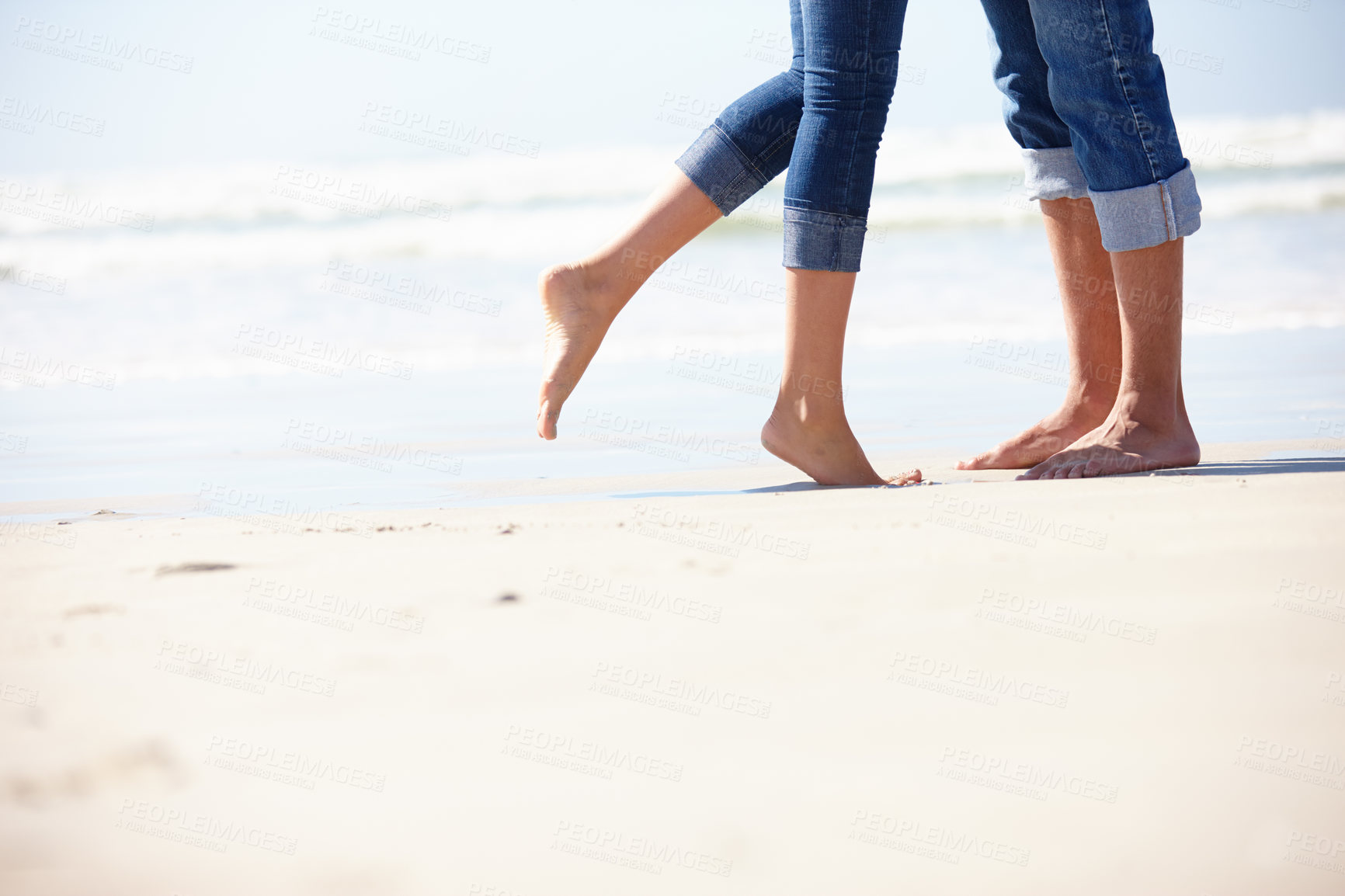 Buy stock photo Couple, beach and love by feet in nature with hug, romance or fun adventure closeup. Legs, zoom or people at ocean for travel, freedom and bonding on sea journey for anniversary, date or honeymoon