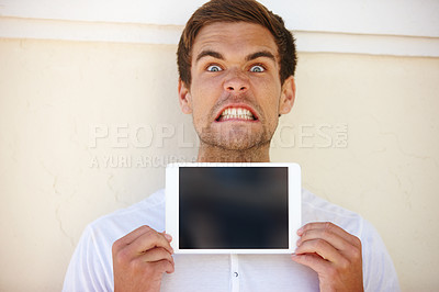 Buy stock photo Angry, portrait and man with tablet screen, mockup or presentation in a city with feedback on wall background. Digital, display or frustrated male person in outdoor with app review for travel problem