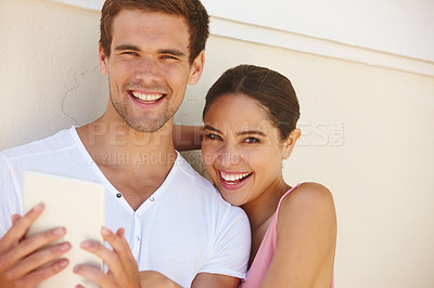 Buy stock photo Couple, portrait and hug with tablet outdoor for photography, summer memories and happiness by wall. Man, woman and smile with technology for social media post, profile picture and travel influencers