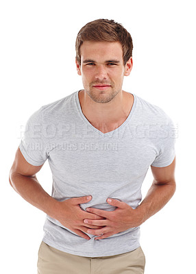 Buy stock photo Stomach ache, pain and portrait of man on a white background with indigestion, hurt and injury. Health, sick and isolated person holding abdomen for nausea, belly problems and tummy cramps in studio