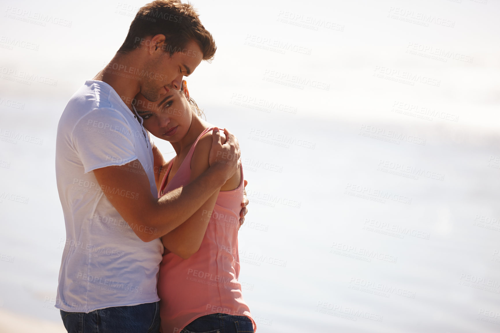 Buy stock photo Couple, hug and comfort at beach with empathy, sad woman and man with love, care and time together outdoor. Safety, security and trust for comfort or support with compassion in relationship
