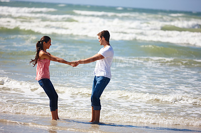 Buy stock photo Couple, holding hands and beach with love for embrace, support or care together on outdoor holiday. Man and woman enjoying summer fun or playing on the ocean coast for bonding together in nature