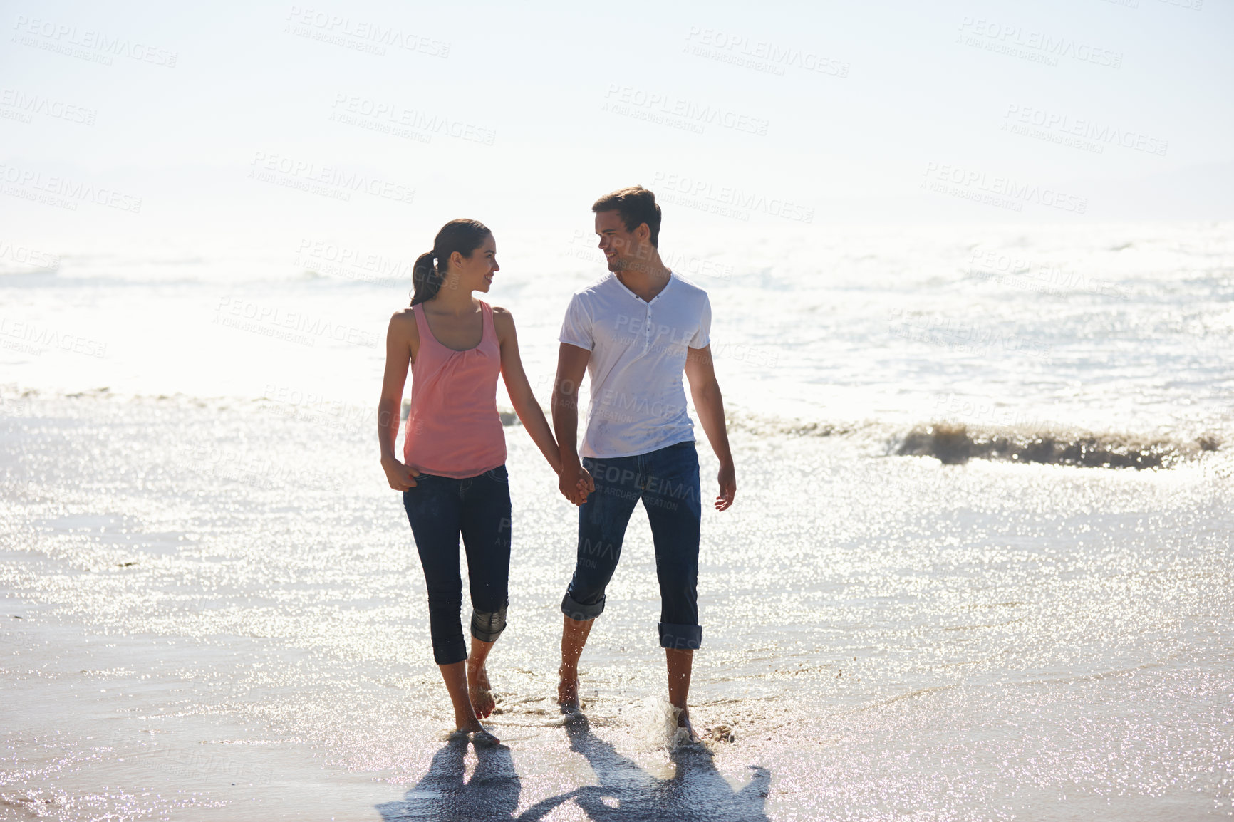 Buy stock photo Love, holding hands and couple at a beach walking, calm and bonding on ocean adventure together. Travel, sunset and people at sea with care, support and trust for summer, holiday or journey in nature