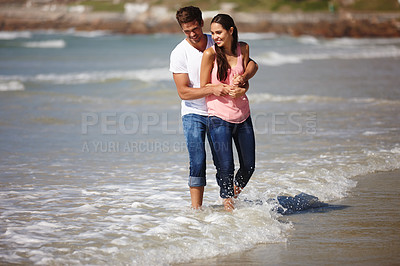 Buy stock photo Happy couple, hug and beach with love, support or care together on outdoor holiday or weekend. Man and woman with smile enjoying fun summer or playing on the ocean coast, water or bonding in nature