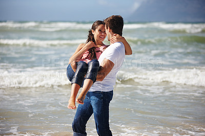 Buy stock photo Ocean, couple and man carrying woman, travel to beach for bonding and anniversary in nature. Happiness, partner and trust in relationship for romance, affection and playful outdoor for love and fun