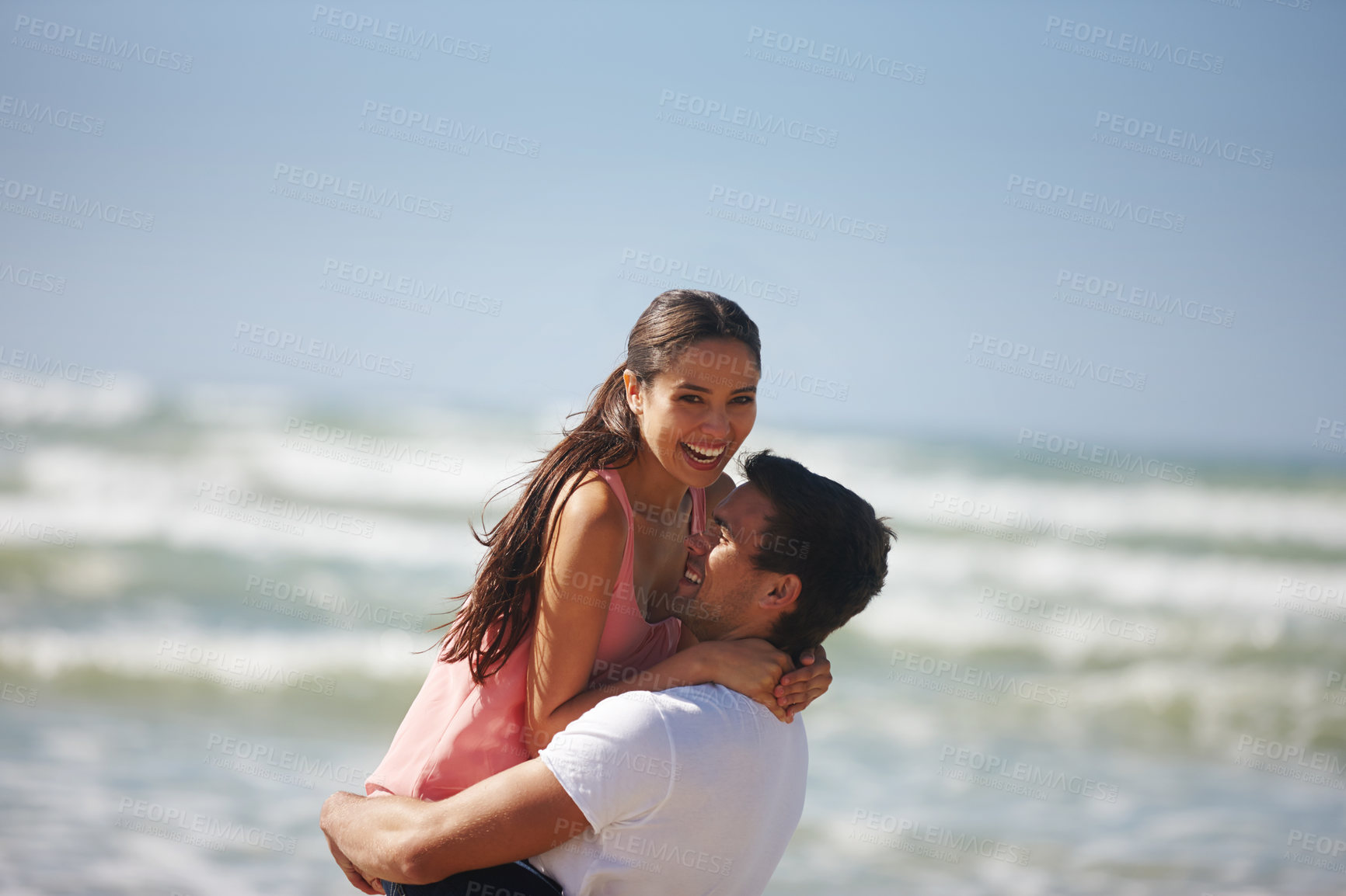 Buy stock photo Happy couple, hug and beach with embrace for love, care or support on holiday, weekend or outdoor vacation. Man lifting woman with smile for relationship, summer fun or bonding by the ocean coast