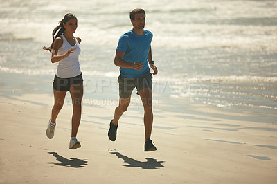 Buy stock photo Couple, fitness and running on beach with partner for exercise, workout or outdoor training together. Man and woman enjoying walk or run for physical activity or cardio on the ocean coast in nature