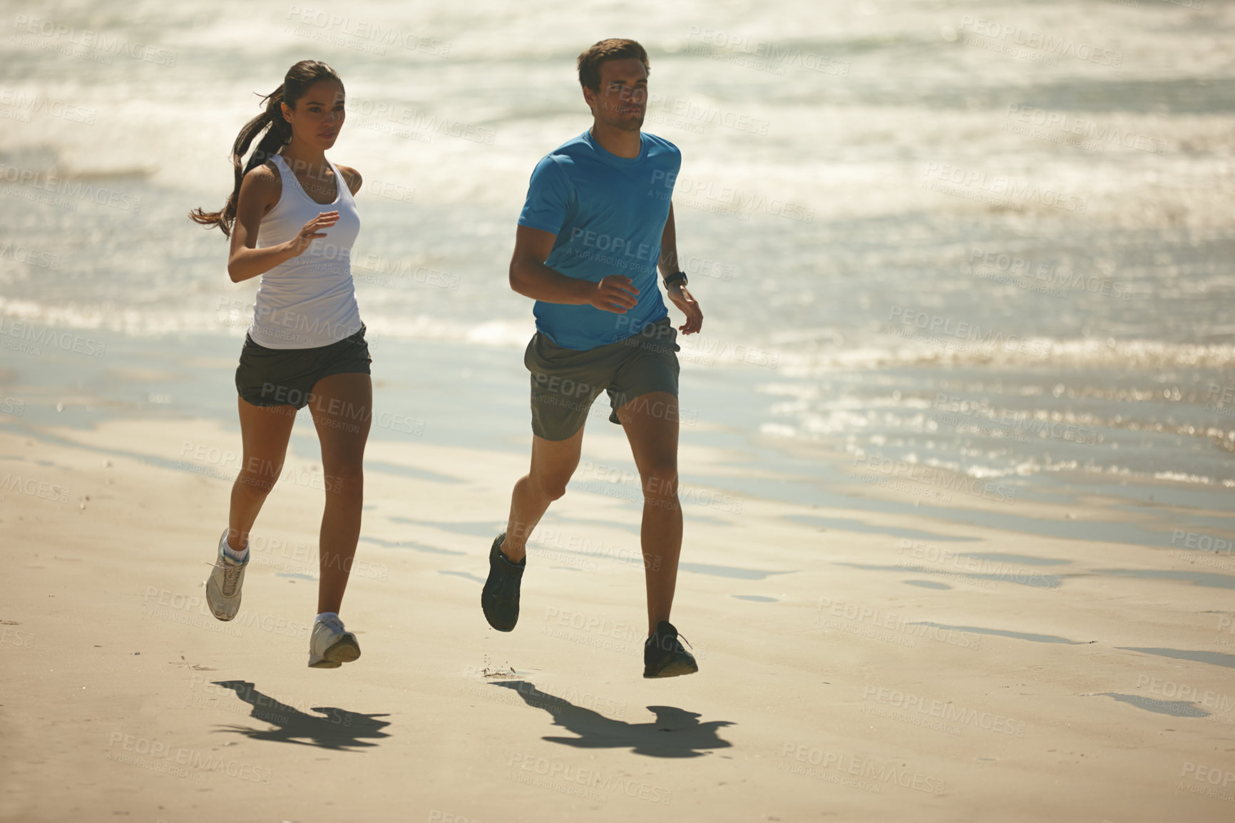 Buy stock photo Couple, fitness and running on beach with partner for exercise, workout or outdoor training together. Man and woman enjoying walk or run for physical activity or cardio on the ocean coast in nature