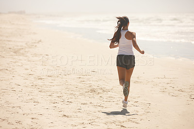 Buy stock photo Shot of a sporty young woman exercising outdoors