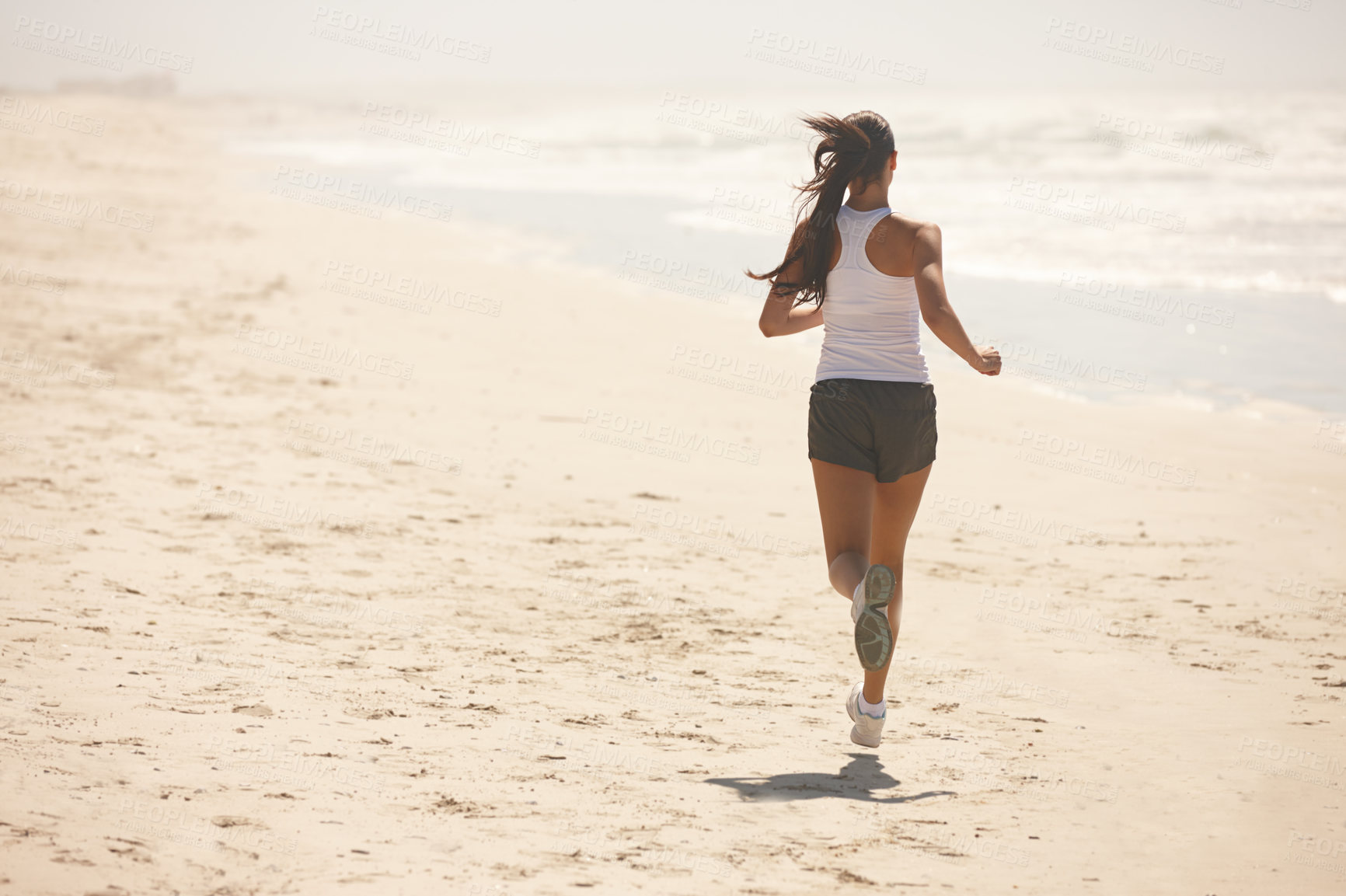 Buy stock photo Shot of a sporty young woman exercising outdoors