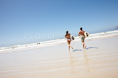 Buy stock photo Couple, beach and surfboard for surfing or running with tide check, adventure and fitness with blue sky. Man, woman and surfer by ocean in the morning for holiday, vacation and freedom with rear view