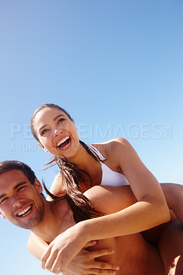 Buy stock photo Happy, laughing and couple piggy back at the beach with love, hug and support together on holiday in summer. Joke, sea and vacation with smile and bonding by water with travel in Miami with people