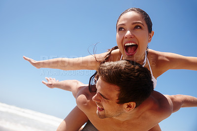 Buy stock photo Couple, piggyback and freedom on beach with playing for bonding, summer vacation or travel adventure. Man, woman and love by ocean with mockup space for happiness, healthy relationship or blue sky