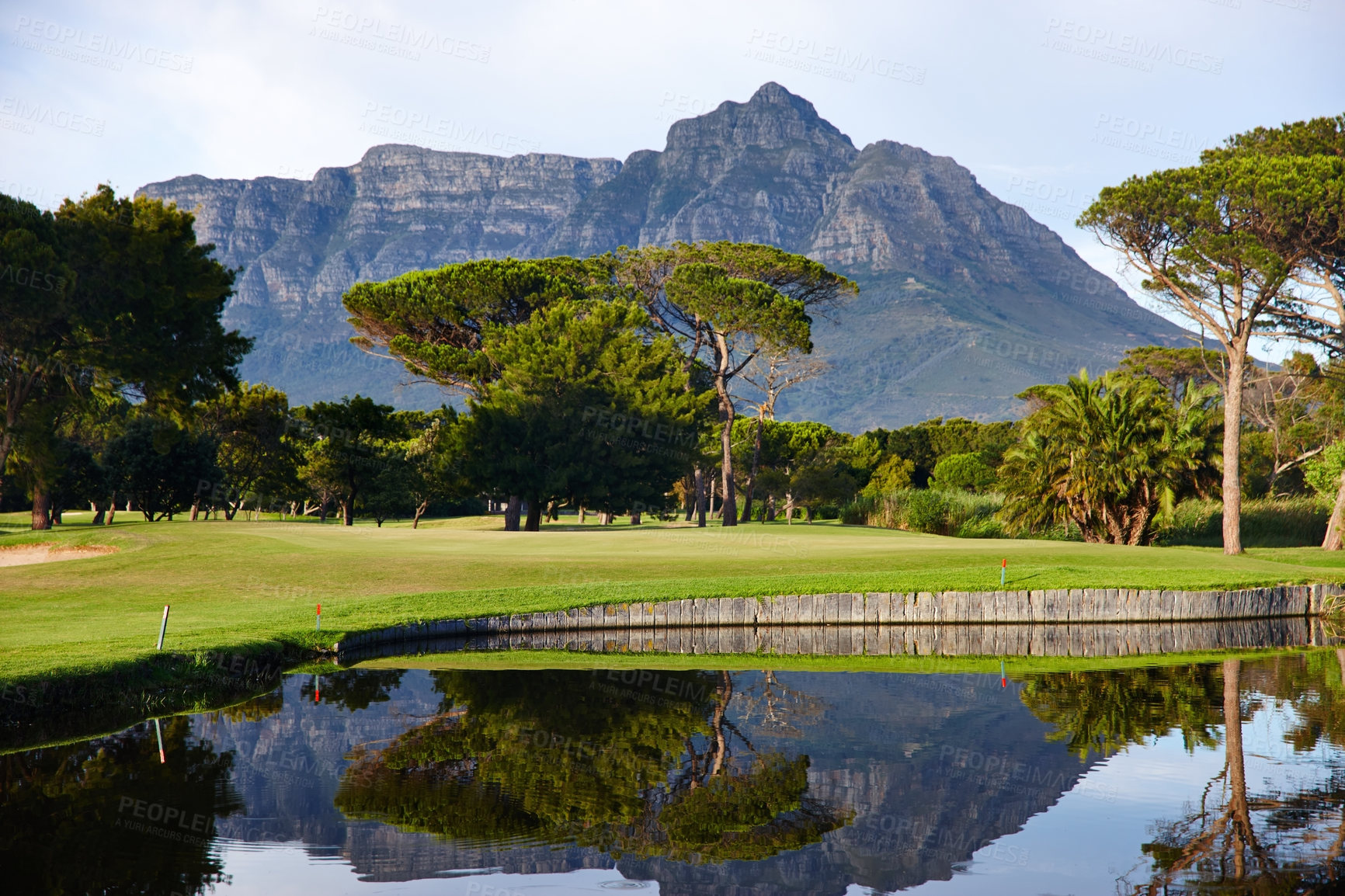 Buy stock photo Golf course, lake and mountain with trees of outdoor nature, scenery or sports ground. Empty field, green grass and view of natural elements with water, forest or colorful turf for park or wilderness