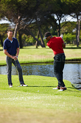 Buy stock photo Man, friends and swing with club on golf course for stroke, score or point in outdoor competition. Male person, people or golfer hitting ball for hole, target or par on green grass or field in nature