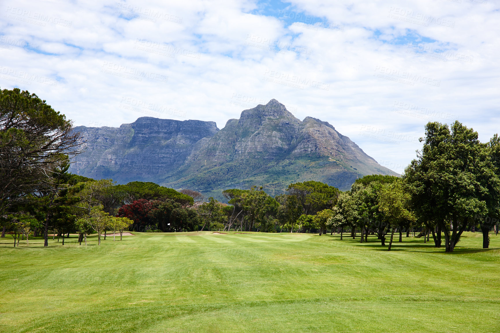 Buy stock photo Mountain, landscape and outdoor on grass at golf course in summer on holiday or vacation. Calm, morning and lawn with turf for sport in woods, forest or nature of countryside with trees on field